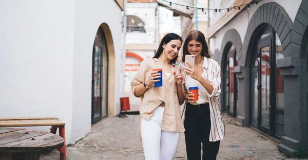 Šťastné Mladé Ženy Turistky Ležérní Oblečení Úsměvem Procházení Smartphone Zatímco — Stock fotografie
