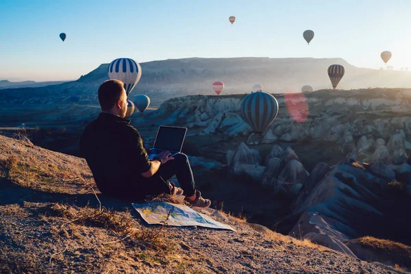 Rückansicht Des Menschen Mit Laptop Und Bewundern Herrliche Heißluftballons Über — Stockfoto