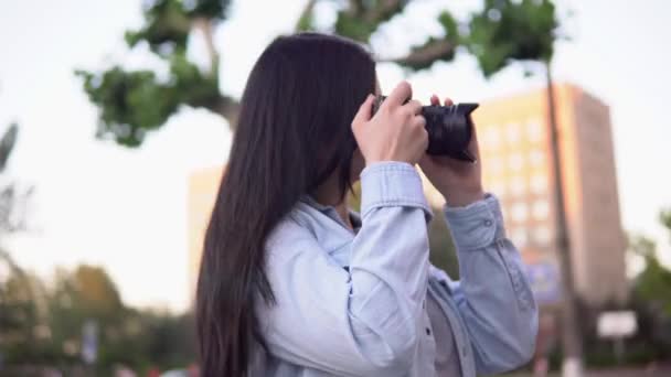 Mujer fotógrafa profesional trabajando en la calle, utilizando la cámara fotográfica haciendo foto — Vídeo de stock