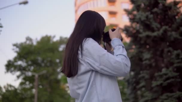 Fotógrafo profesional trabajando en la calle, mujer con cámara fotográfica haciendo foto — Vídeo de stock