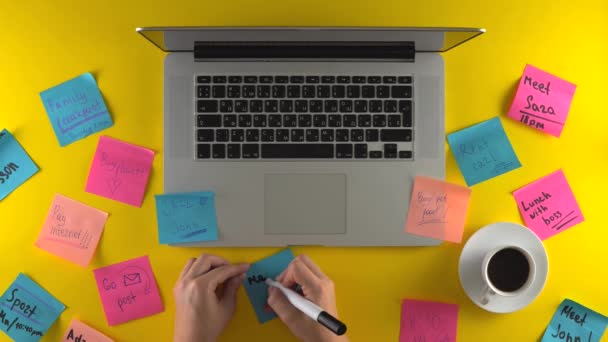 Writing new remind note, post it papers on work place — Stock Video