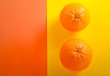 Portakal, düz renkli arka plan üzerinde yatıyordu