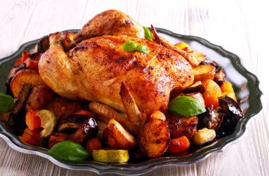 Roast chicken with vegetables: potatoes, carrot, zucchini, eggplant clipart