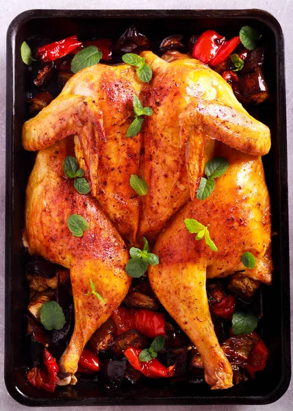 Roast chicken with vegetables and mint in a tin