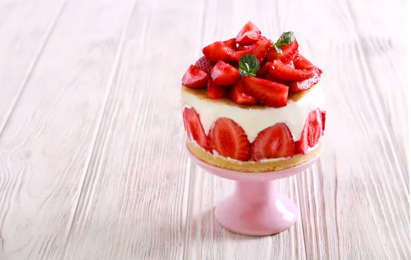 Strawberry cream and yogurt cake on plate over wooden background