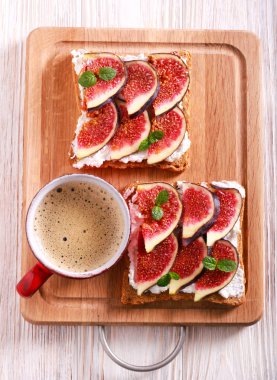 İncir ve ricotta sandviç ve kahve ahşap tahta üzerinde açın