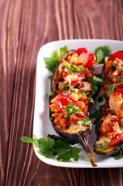 Aubergine stuffed with chicken fillet, tomato and cheese