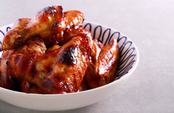 Grilled sticky chicken wings in a bowl