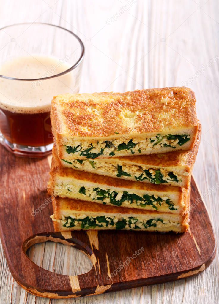 Spinach and cheese grilled sandwiches and glass of coffee