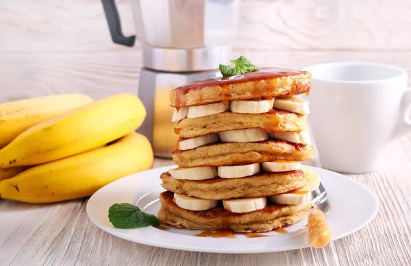 Banana wholewheat pancakes with caramel on plate
