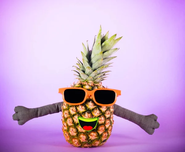 Pineapple in sunglasses - party, fun concept over colorful background