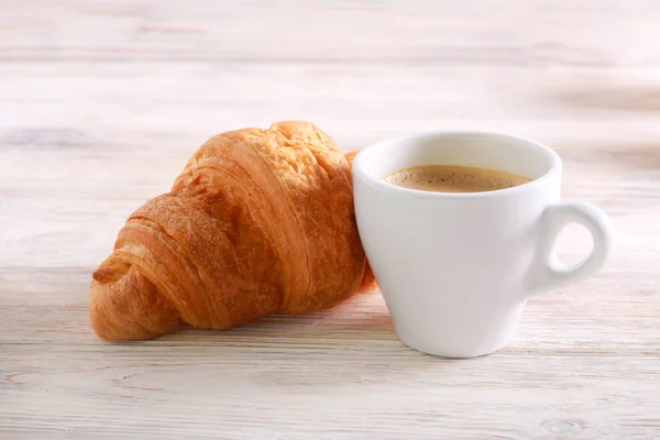 Croissant Und Tasse Kaffee Vor Holzhintergrund — Stockfoto