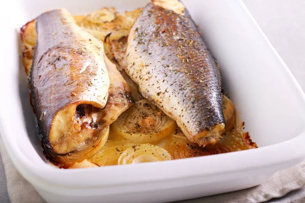 Baked sea bass fish on onions — Stock Photo, Image