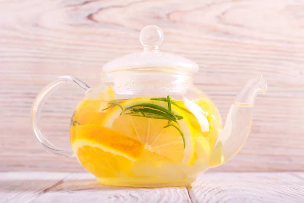 Citrus and rosemary tea in a teapot — Stock Photo, Image