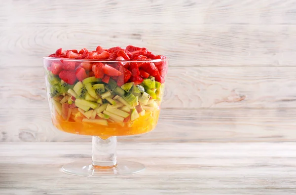 Layered rainbow fruit and berry salad