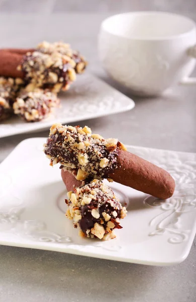 Chocolate butter logs with nuts — Stock Photo, Image