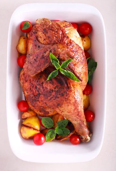 Roast chicken half with potatoes and tomatoes — Stock Photo, Image