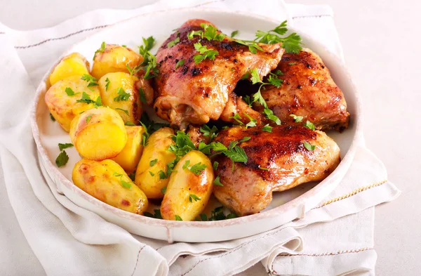 Roast chicken thighs and roast potatoes — Stock Photo, Image