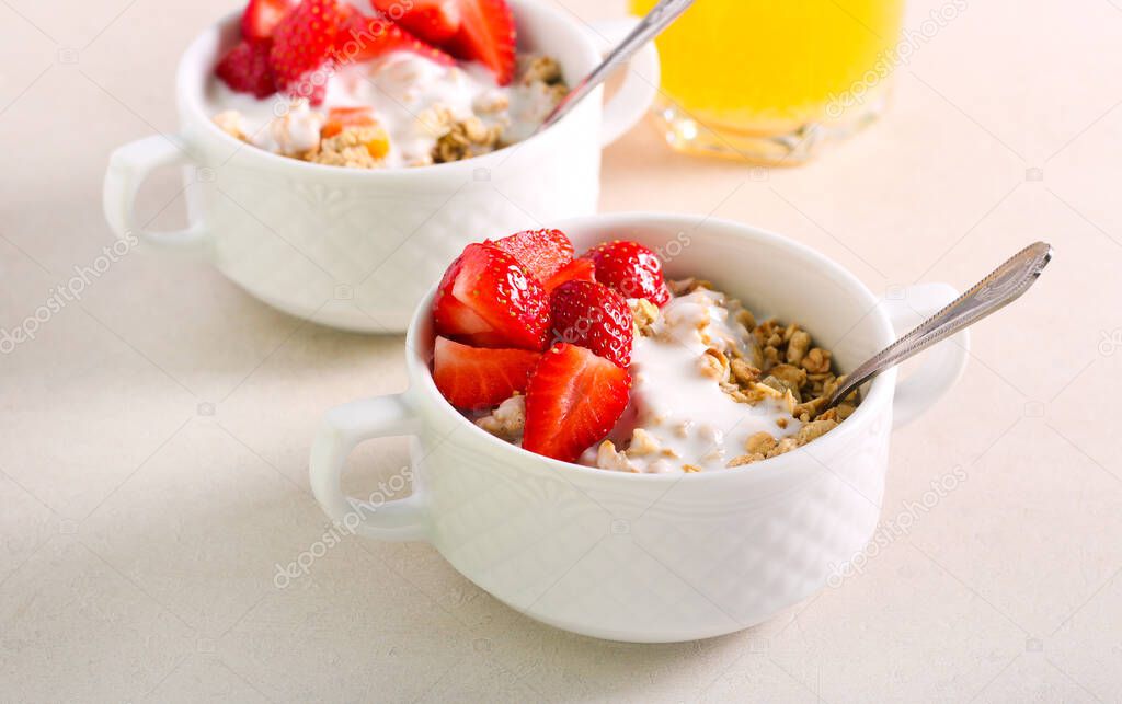 Muesli with yogurt and strawberry in bowls