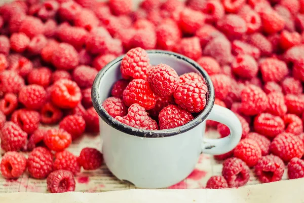 Mavi ahşap bir masa üzerinde bir kutu içinde kırmızı ahududu. Taze çilek arka plan. Detoks Diyet ve yaz gıda kavramı. Portre.