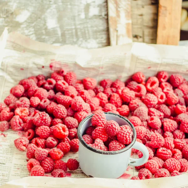 Mavi ahşap bir masa üzerinde bir kutu içinde kırmızı ahududu. Taze çilek. Sağlıklı ve ham antioksidan gıda kavramı. Instagram boyutu
