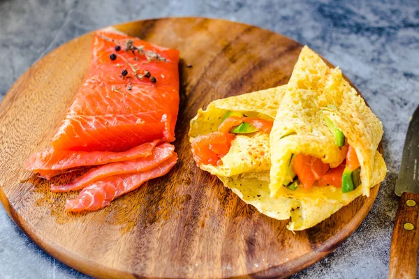 Thin pancakes with red fish on plate, top vie — Stock Photo, Image