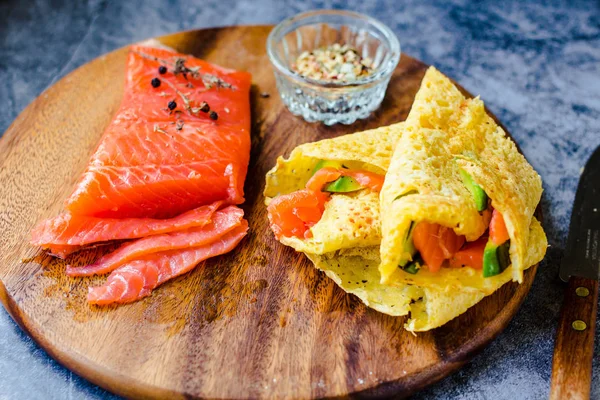 Thin pancakes with red fish on plate, top vie — Stock Photo, Image