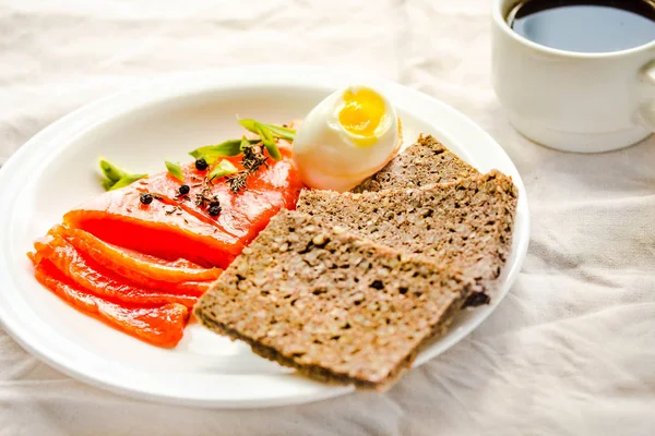 Slices of Salted Raw fish fillet with egg and piece of buckwheat