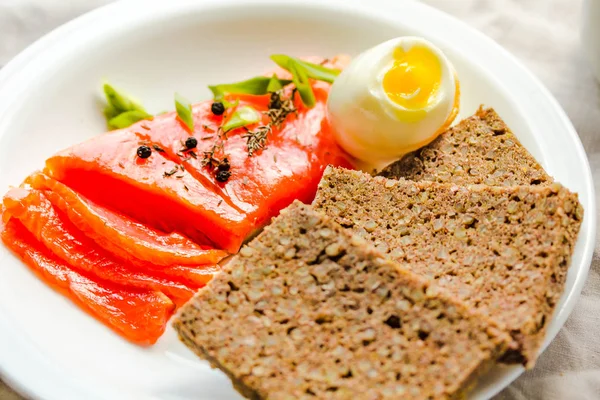 Slices of Salted Raw fish fillet with egg and piece of buckwheat — Stock Photo, Image