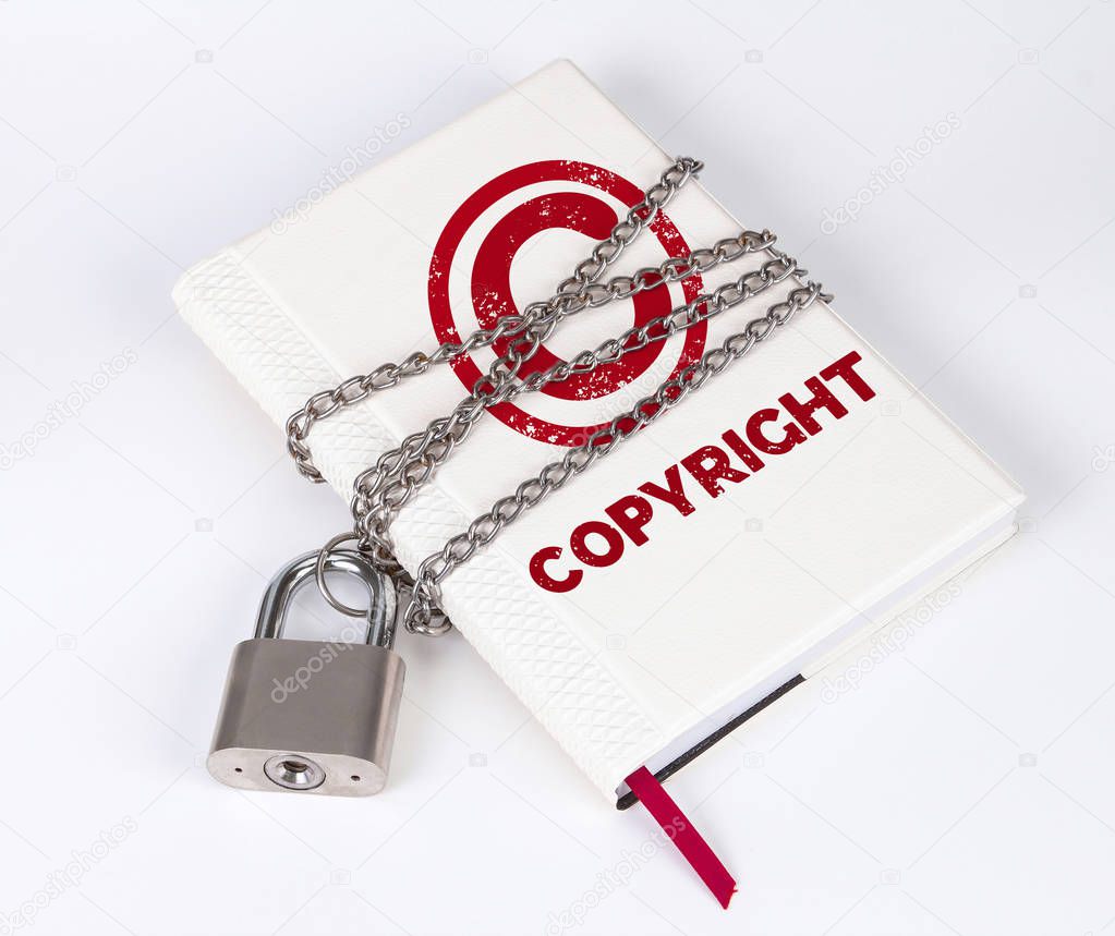  padlock protects the book in a concept with COPYRIGHT text and symbol on protect the top secret information