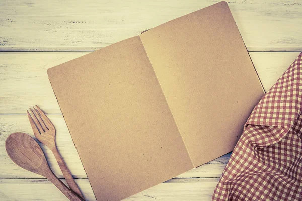 blank page of book notepad paper opened and tablecloth on white table , recipes food  for healthy habits shot note background concept