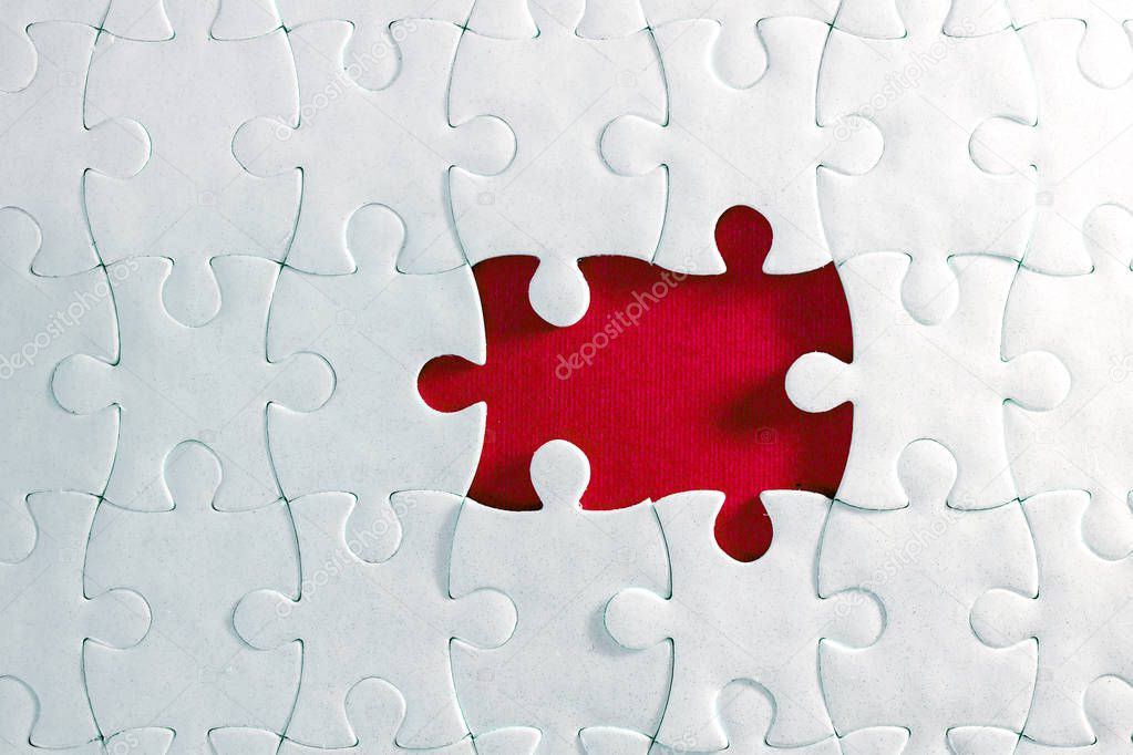 Close up piece of white jigsaw puzzle , concept of business challenge completion with teamwork