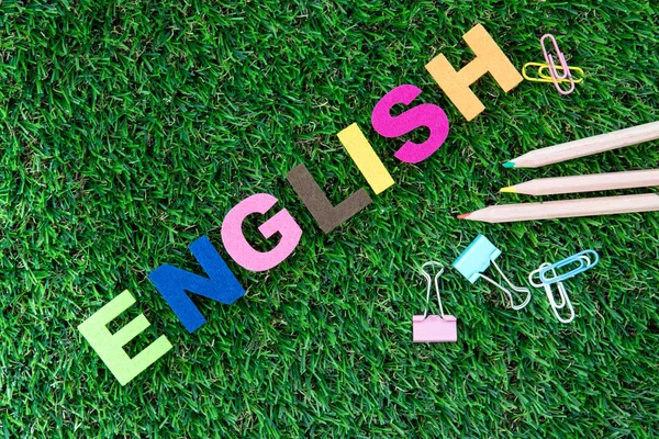 Colorful ENGLISH word cube on a green grass yard  background ,En — Stock Photo, Image