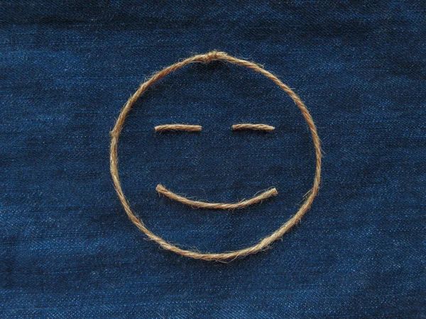 Funny smiley of twine in denim. Emoji