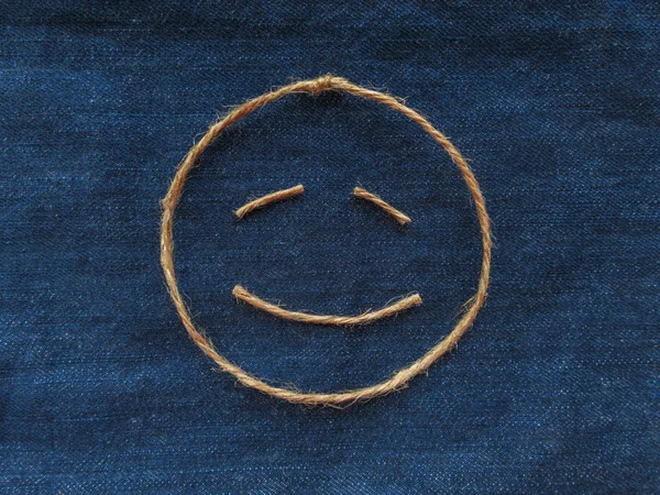 Funny smiley of twine in denim. Emoji