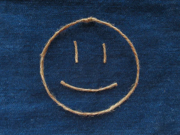 Funny smiley of twine in denim. Emoji