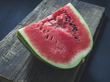 Taze kırmızı olgun karpuz ahşap bir arka plan üzerine dilimlenmiş