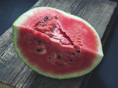 Taze kırmızı olgun karpuz ahşap bir arka plan üzerine dilimlenmiş