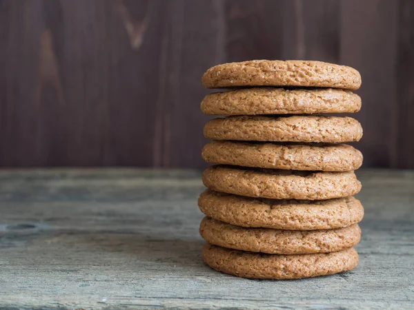 Healthy oatmeal burger. Oatmeal cookie stack on wooden background. Useful sweets closeup