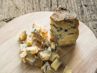 Ahşap arka plan üzerinde kalıp ile mavi kokulu İngiliz peyniri Stilton Dilim. Closeup