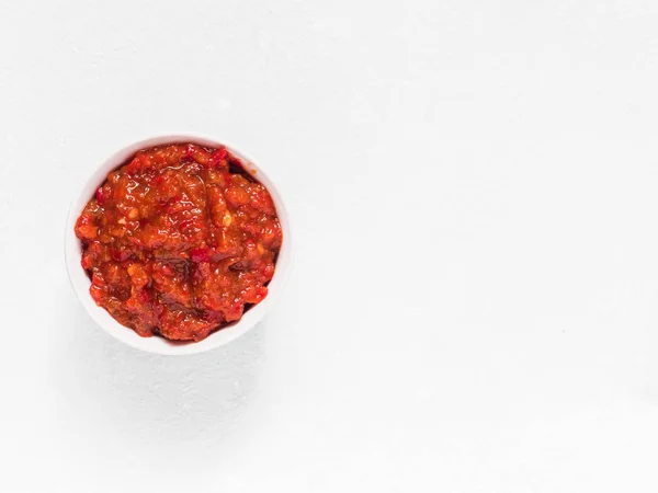Gochujang. Traditional Korean soybean paste with sticky rice and fermented soybeans, dressed with red pepper in high concentration in a white bowl — Stock Photo, Image