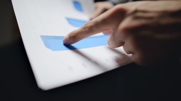Close-up of male hands pointing at business document — Stock Video