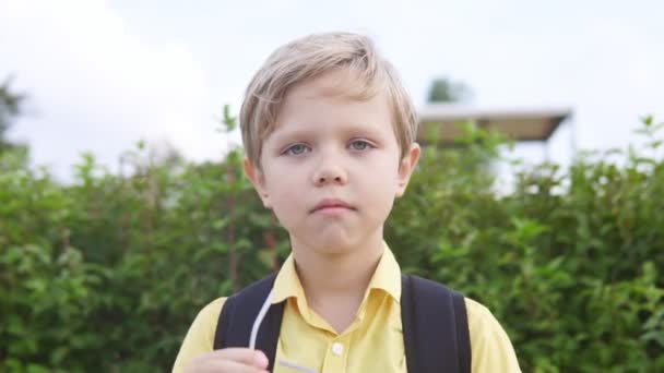 Bliska portret małego chłopca blond wprowadzenie na okulary i uśmiechnięty — Wideo stockowe
