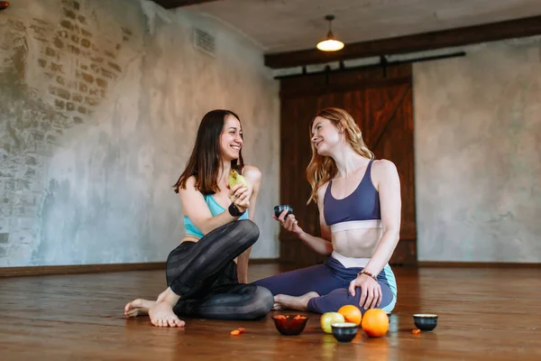 Conversation and tea party of two yogis in the loft