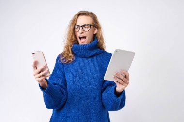 bir telefon ve bir tablet onun elinde beyaz bir arka plan üzerinde kızgın kız