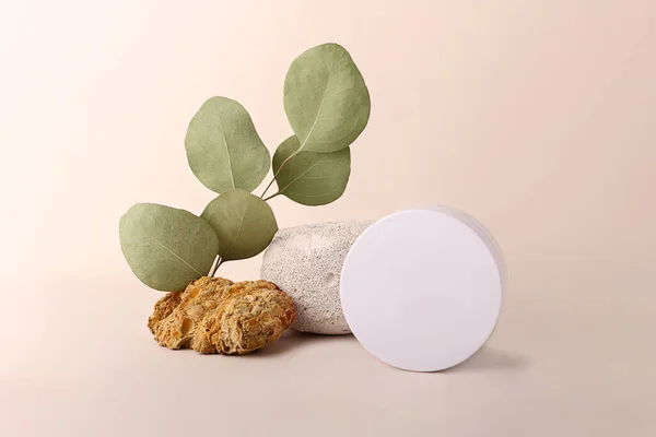 Composition from the natural materials and round cosmetics box near it.Copy space for text or design.Can be used as advertising banner.Pastel colors.