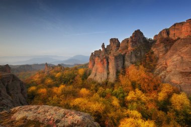 Belogradchik rocks. Magnificent morning view of the Belogradchik rocks in Bulgaria, lit by the autumn sun. clipart