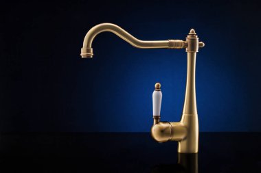 Modern mutfak musluk koyu mavi arka plan karşı.