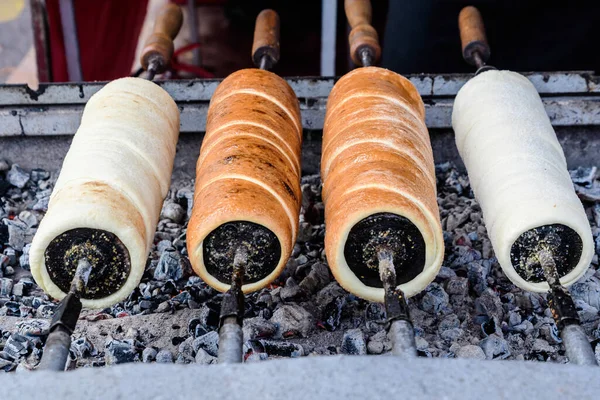 Four Fresh Kurtos Kalacs Chimney Cakes Being Cooked Rolls Spinning — Stock Photo, Image