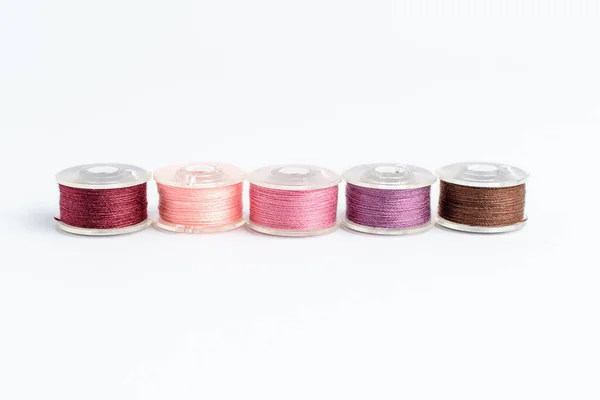 Five Spools Burgundy Light Pink Pink Mauve Brown Threads Prepared Stock Picture